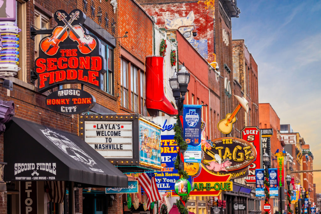 Nashville, TN, USA - 12-24-2023: Famous Neon signs of blues clubs on Beale street at day in downtown Nashville city attraction